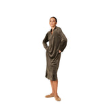 A model wearing a long-sleeve Khaki velvet midi lounge dress by Pluto, featuring a V-neckline with a collar, side pockets, and a relaxed, draped silhouette.