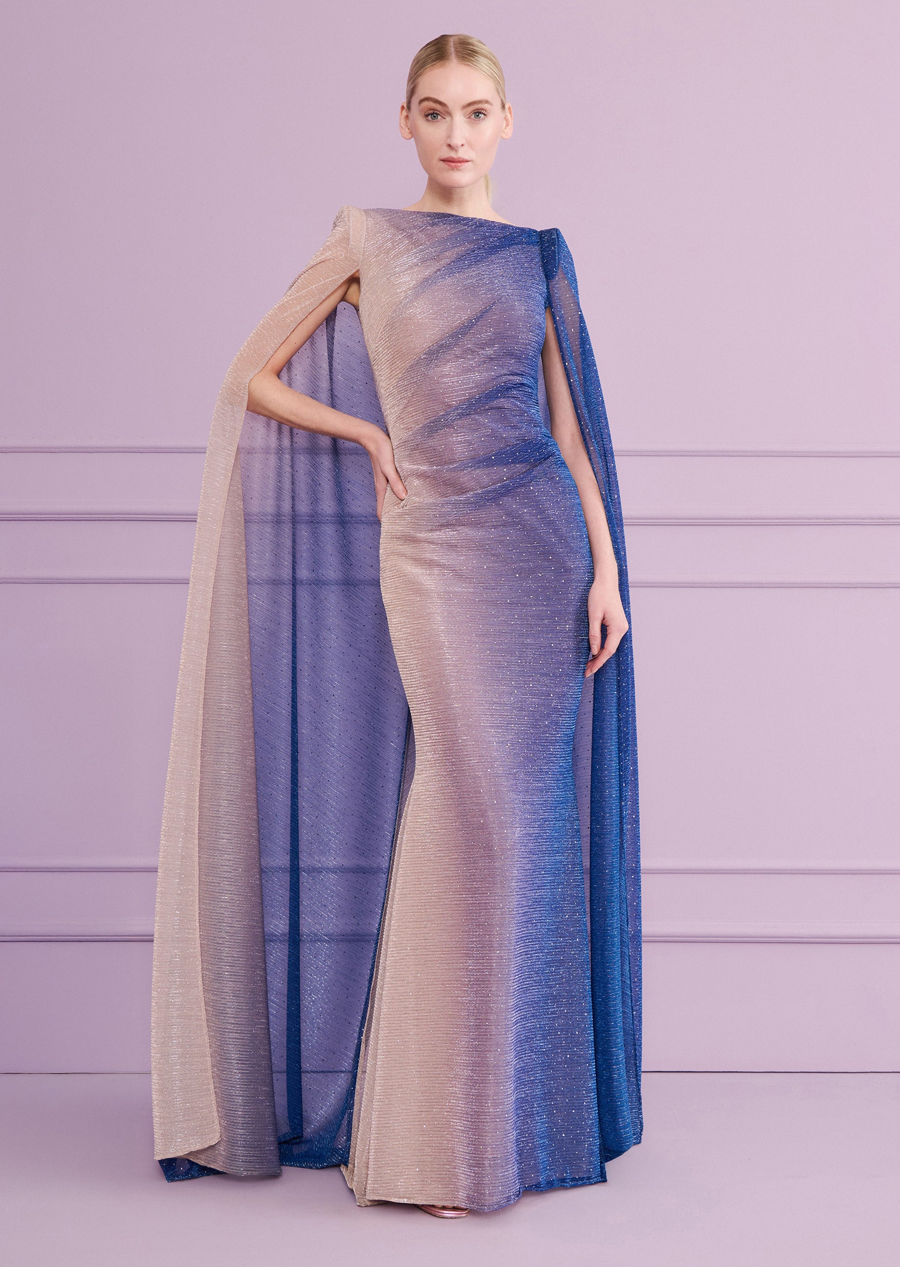 Ombre glitter mermaid gown with boat neck and floor-length cape sleeves, transitioning from champagne to cornflower blue.