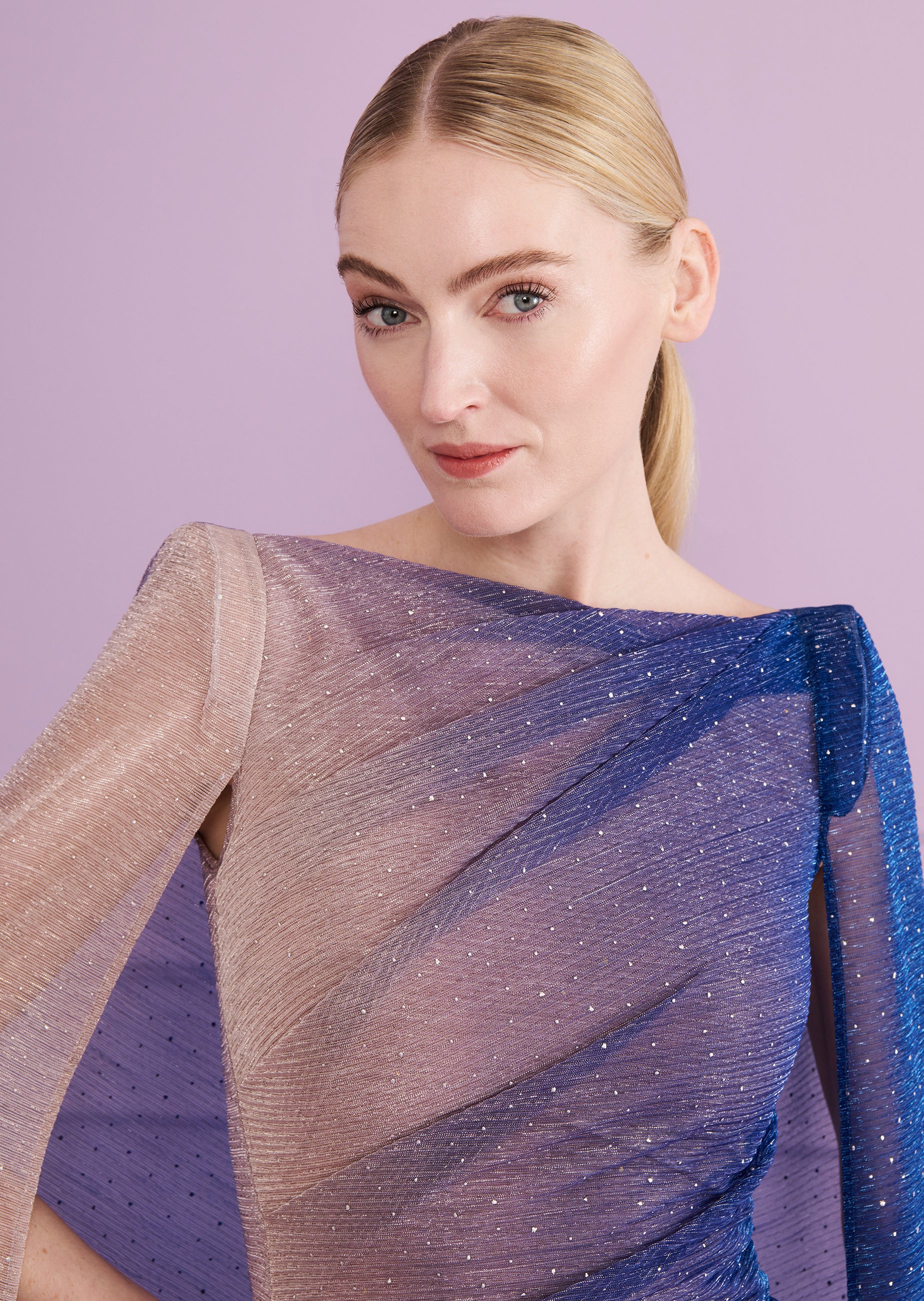 Sheer, pleated long dress with an ombre effect from light beige to cornflower blue, featuring scattered silver glitter and a