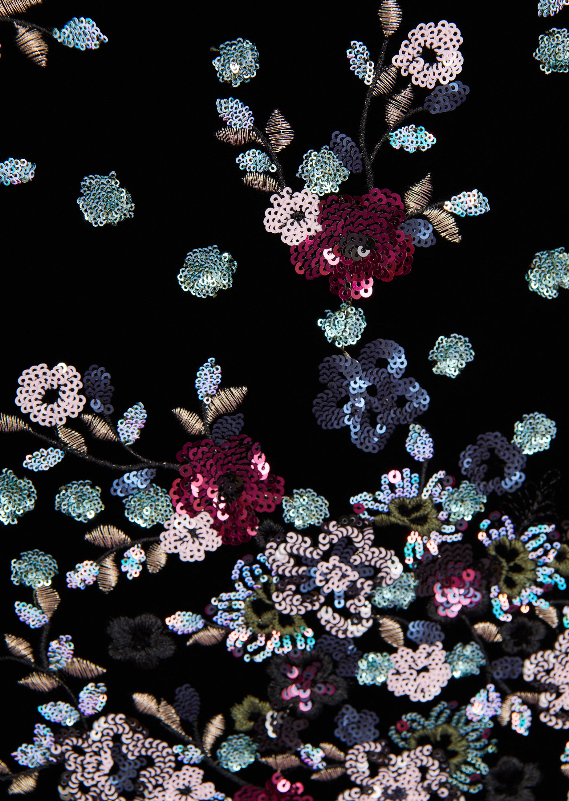 Black fabric with dense floral embroidery of pink, blue, white iridescent sequins and gold-toned thread.