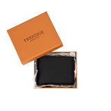 Prestige black leather bi-fold wallet in a luxury orange gift box.