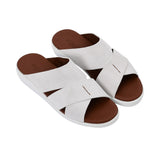 Top-down angled view of a pair of Prestige Italian-made suede slides on a white background.