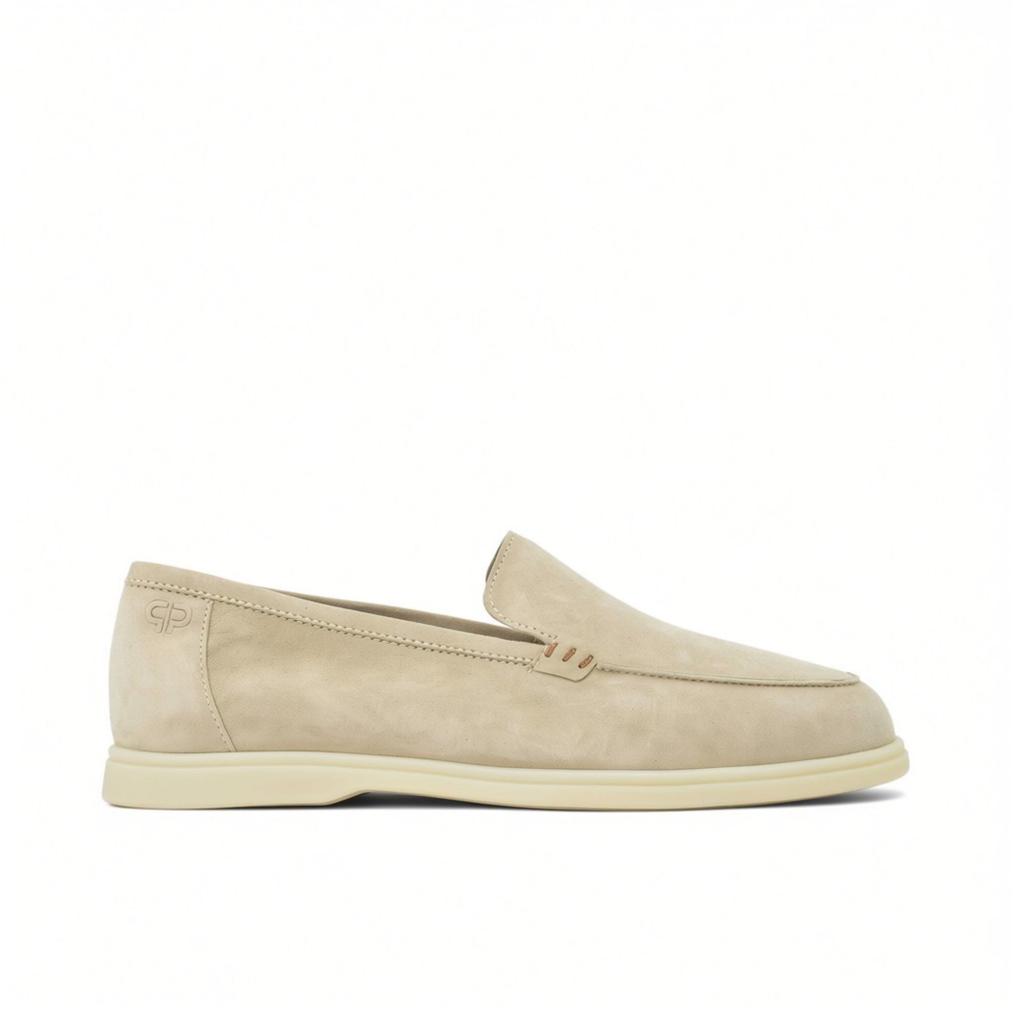 A crisp side-profile view of a single men's slip-on loafer in a soft, beige suede material. The shoe features a low-profile white rubber sole, minimalist tonal stitching along the upper edge, decorative brown contrast stitching details on the side of the tongue, and a subtle "GP" logo embossed near the heel counter.