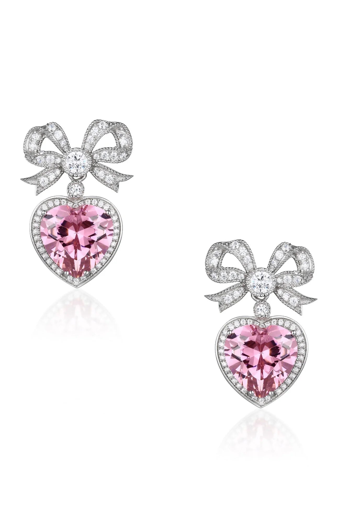Pair of silver-toned drop earrings, each featuring a pavé-set bow above a faceted pink crystal heart with a halo of small sto