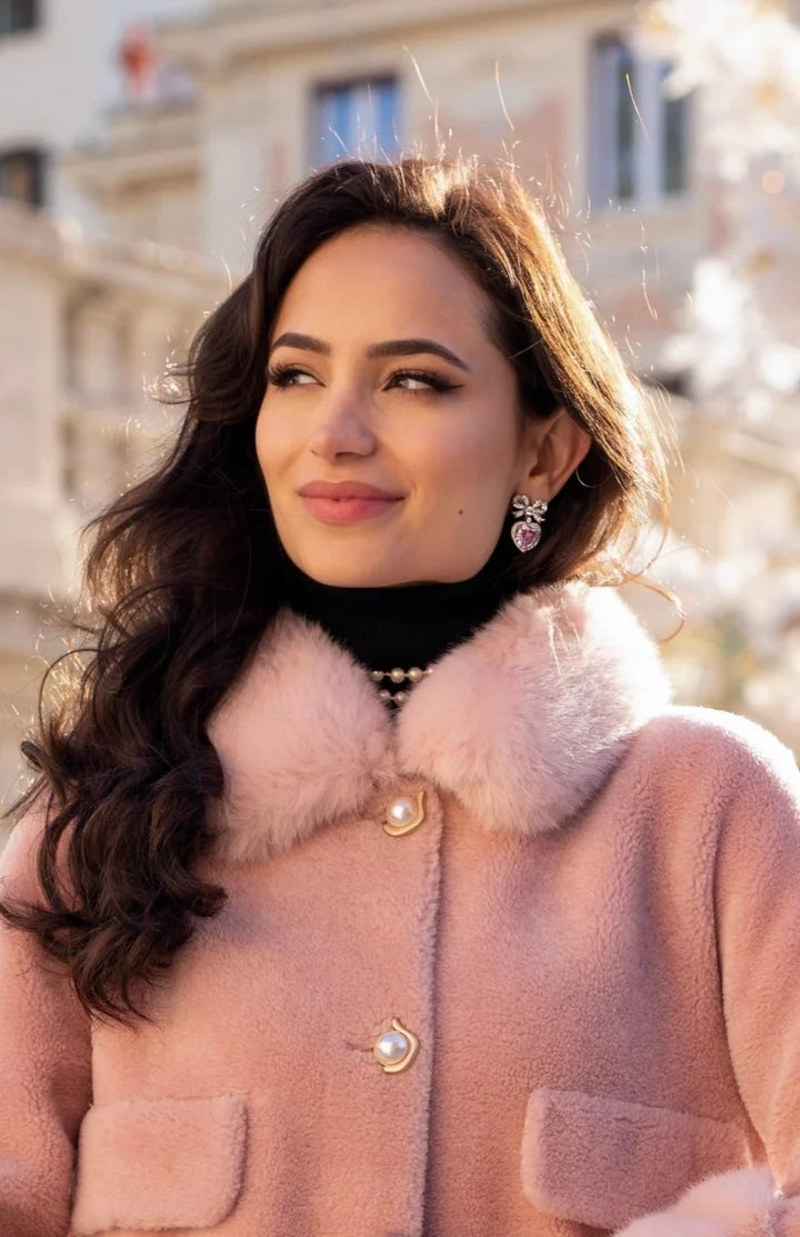 Silver-toned earring with a crystal-studded bow top and a pink crystal heart drop.