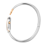 A side profile photograph accentuating the complete circular architecture of the polished rigid steel bangle, the integrated rear case hinge, and the fluted rose gold setting crown on the side of the horseshoe watch head.