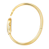 A side profile shot showcasing the complete circular architecture of the polished gold-plated rigid bangle, the integrated case hinge, and the fluted crown detailed on the side of the horseshoe watch head.