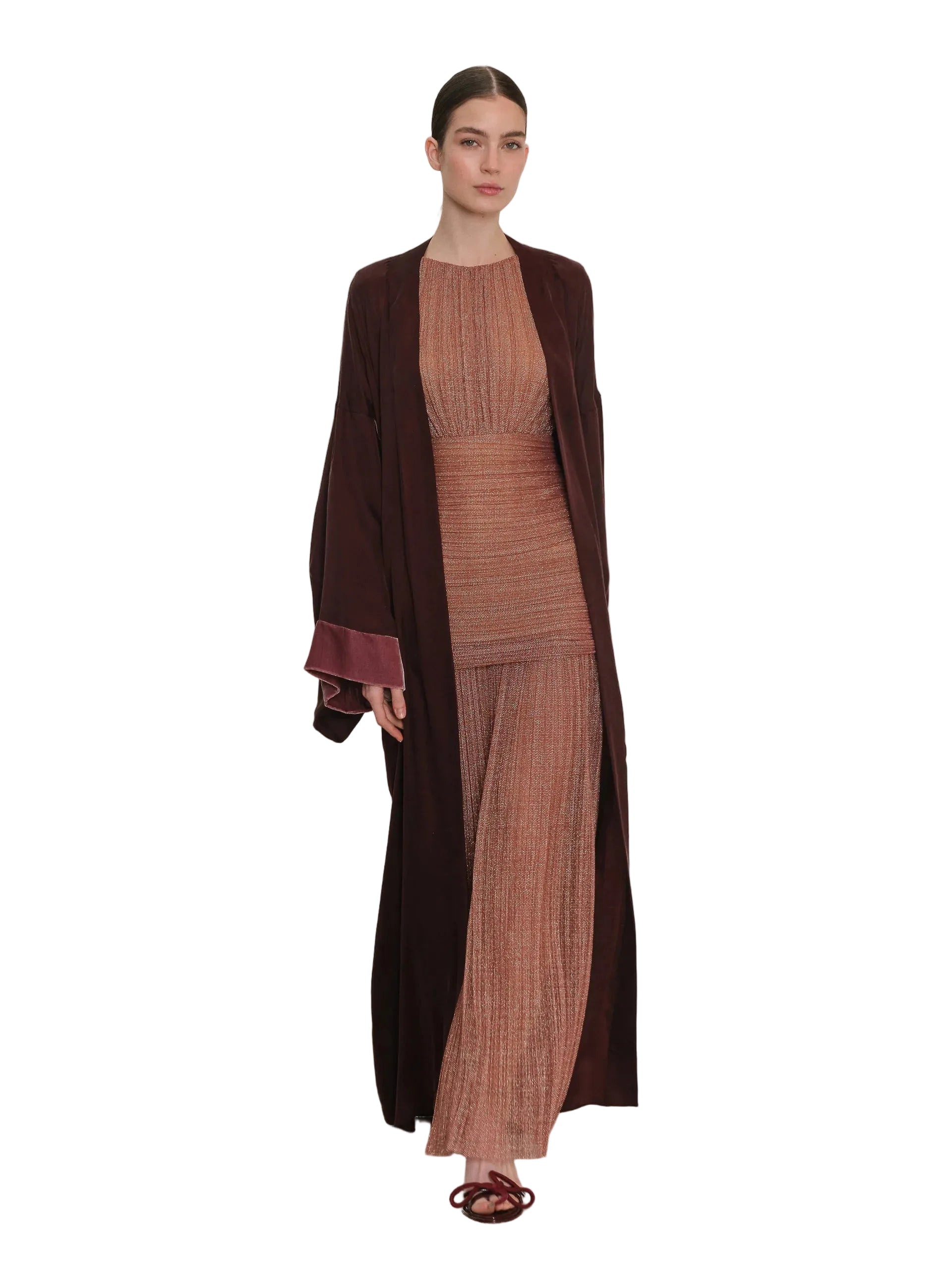 Dark burgundy open abaya with wide sleeves and velvet-like cuffs. Worn over a shimmery copper-toned pleated dress with a ruch
