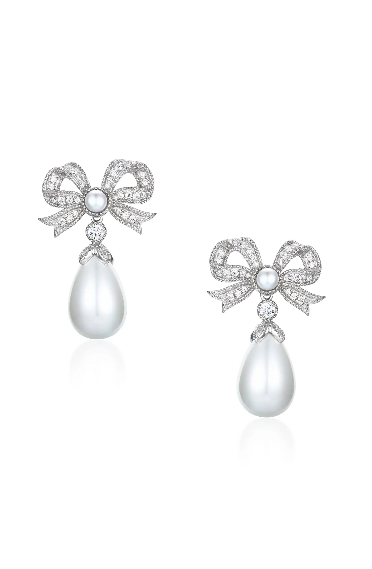 Pair of silver-toned bow-shaped drop earrings with clear faceted stones, a central white round pearl, and a dangling white te