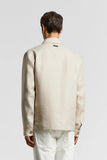 Beige pure linen Saharan jacket, back view. Features a shirt collar, back yoke, long sleeves with single-button cuffs, and a