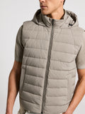 Light taupe quilted microfiber down vest with a hood, full-zip front, and two vertical slit pockets. Black toggles on hood.