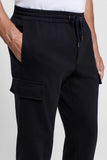 Dark blue jersey cargo trousers with an elasticated drawstring waist, gold-toned aglets, side slash pockets, and a flap cargo