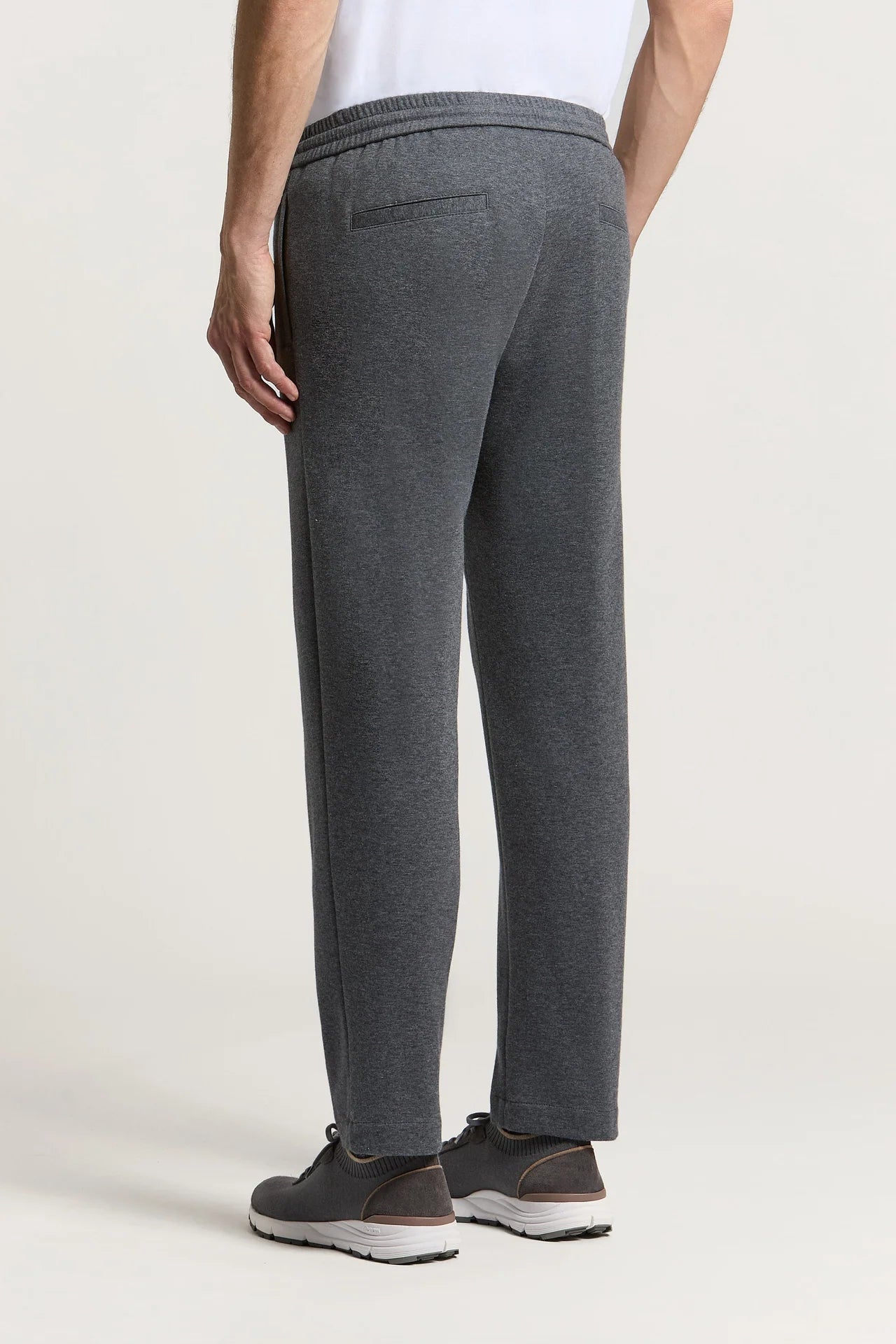 Charcoal grey trousers with an elasticated waistband and a horizontal welt pocket on the right rear. Straight leg.