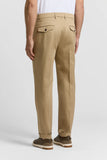 Beige pure cotton gabardine chino trousers, back view, with two dark-buttoned flap pockets and cuffed hems.