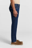 Dark blue slim fit cotton twill jeans with five-pocket styling, contrast stitching, gold-toned rivets, and a small back pocke