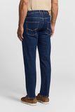 Dark blue slim fit cotton twill jeans, seen from the back. Features gold-toned stitching, two back pockets with V-shaped desi