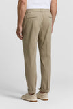 Beige cotton poplin jogger trousers with an elasticated waist, two back welt pockets, and cuffed hems.