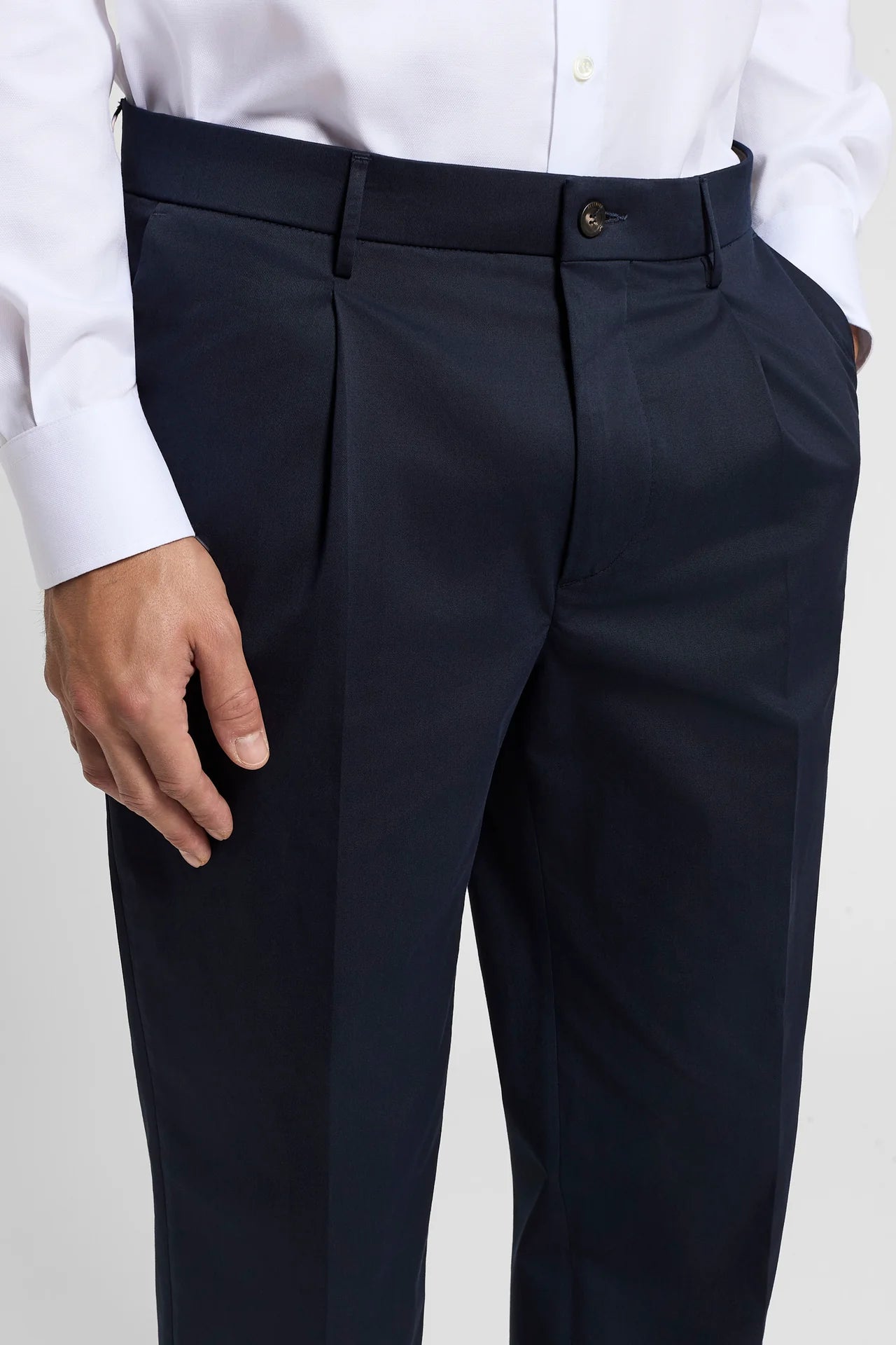 Dark blue pure cotton gabardine trousers with a single front button, belt loops, front darts, and side pockets.