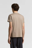 Light brown pure cotton crewneck T-shirt with short sleeves and a smooth texture, seen from the back.