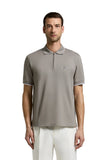 Taupe piquet polo shirt with a black zipper placket, short sleeves with white trim, and a small circular logo on the left che