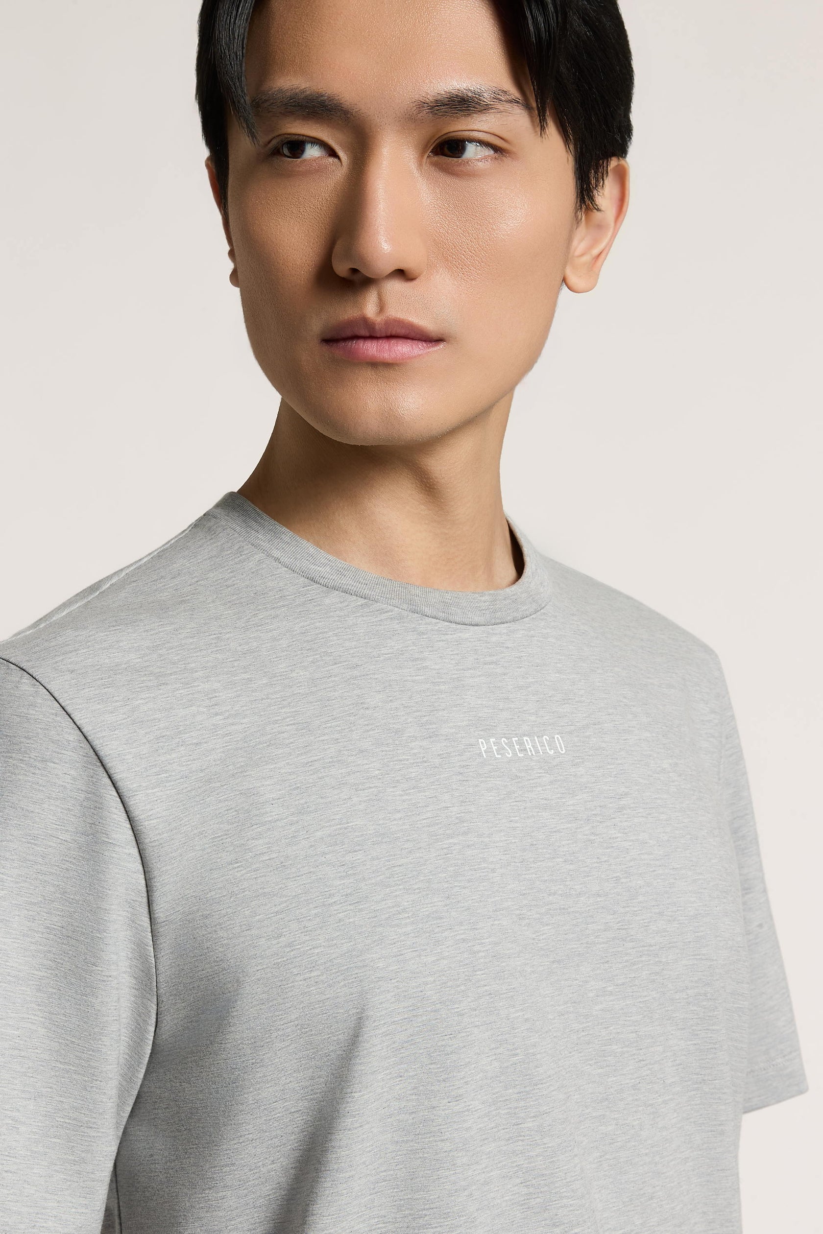 Carbon grey heathered crew neck t-shirt with short sleeves and 'PESERICO' printed in white on the left chest.