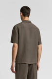 Brown linen canvas camp shirt with short sleeves, a collar, and a back yoke.