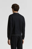 Dark blue cotton jersey bomber-style sweatshirt, back view. Ribbed hem and cuffs, plus a small brown label at the back neck.