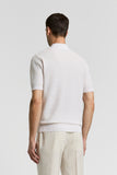 Shell beige short-sleeved polo sweater with a textured knit, ribbed collar, cuffs, and hem, viewed from the back.