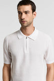Shell beige knitted polo shirt with a classic collar, short ribbed sleeves, and a half-zip placket with a dark zipper.