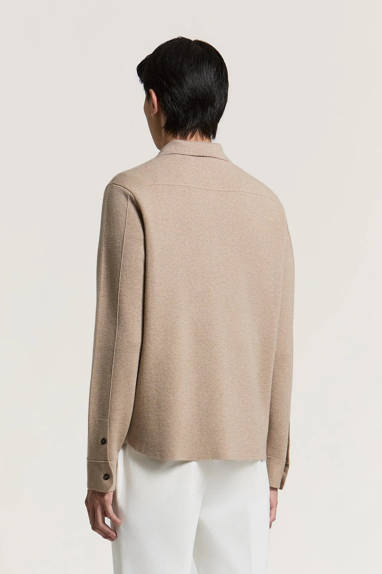 Earth beige collared sweater with long sleeves, buttoned cuffs, and a back yoke seam.