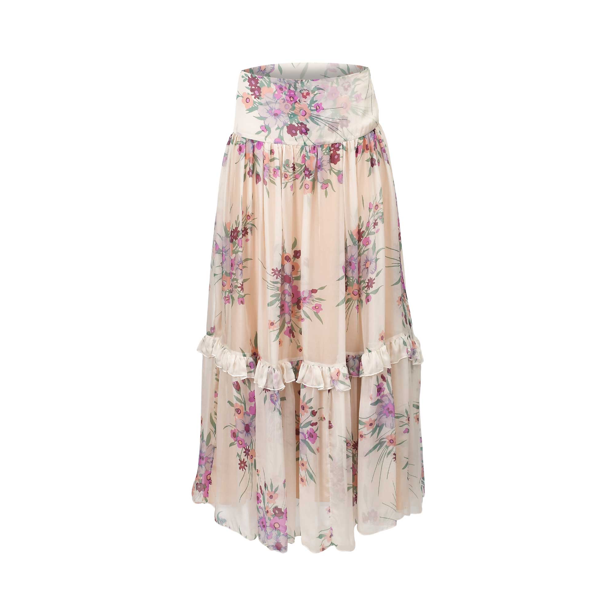 Light beige maxi skirt with a wide waistband and tiered construction, featuring a lilac and purple floral print and ruffled s