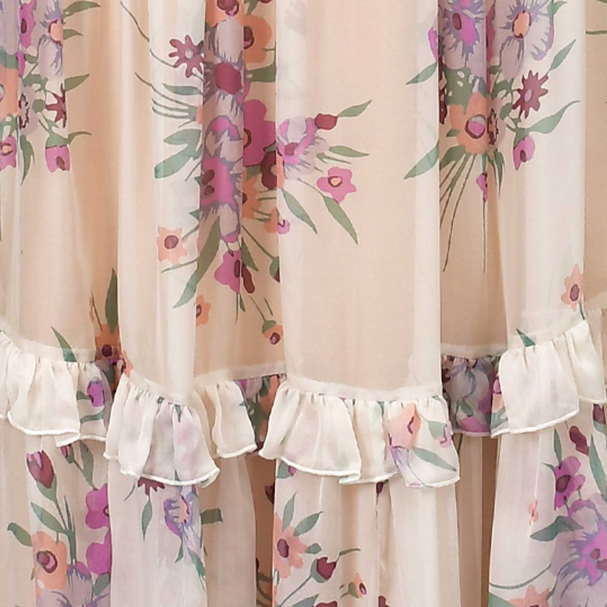 Light beige skirt with a floral print in lilac, pink, orange, and green. Features tiered ruffles at the hem.