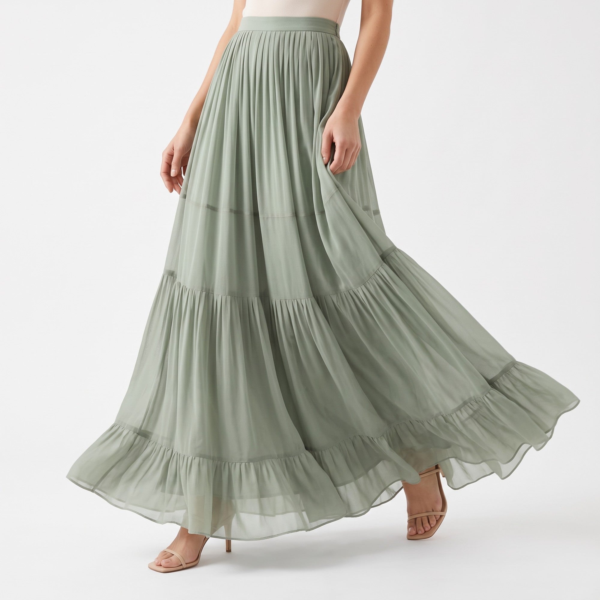 Sage green maxi skirt with a pleated top, three gathered tiers, and a ruffled hem. Made of a lightweight, flowy fabric.