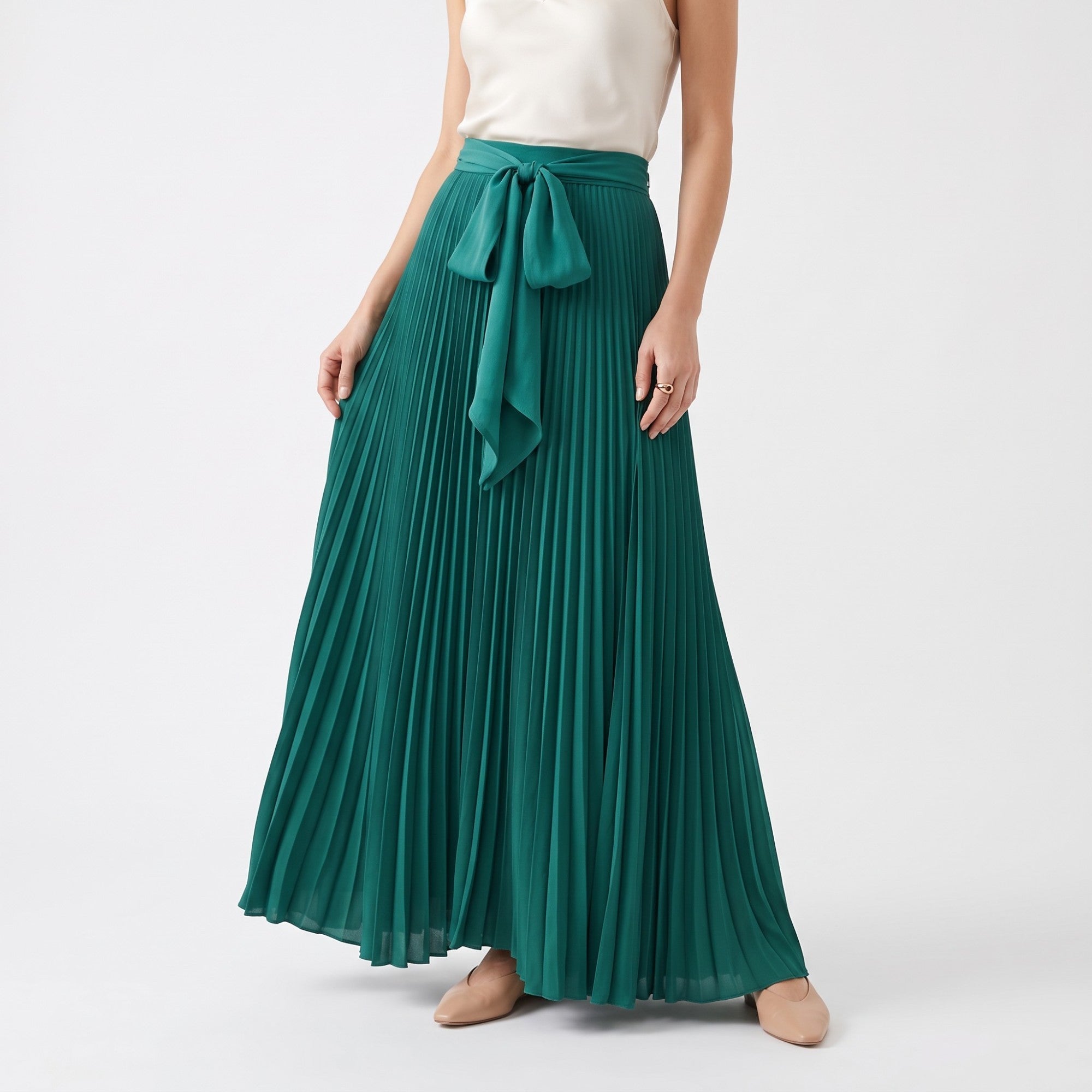 Green pleated maxi skirt with a matching tie-belt tied in a bow at the waist.