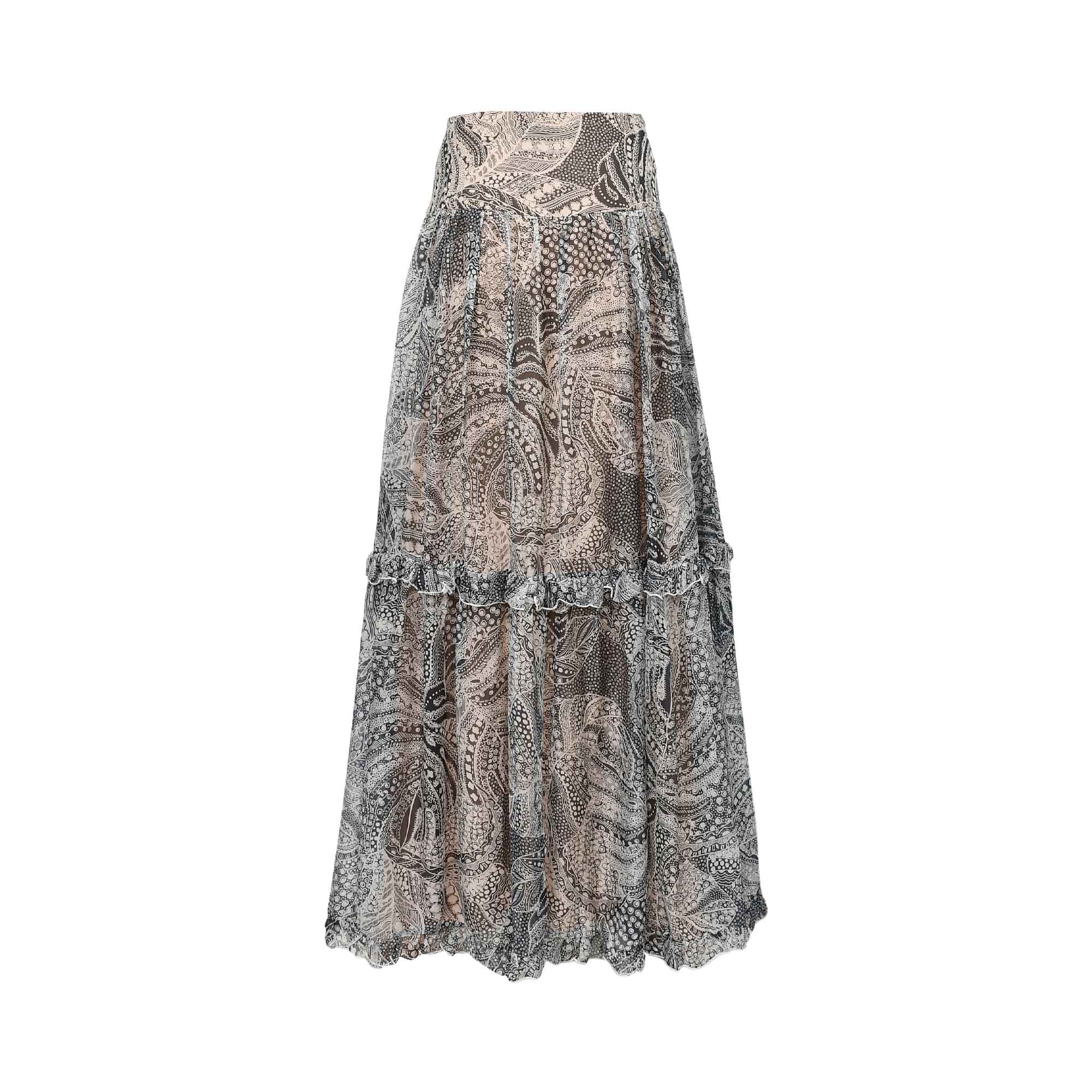 Long tiered skirt with black, white, and beige intricate paisley pattern, ruffled seam, and wavy hem.