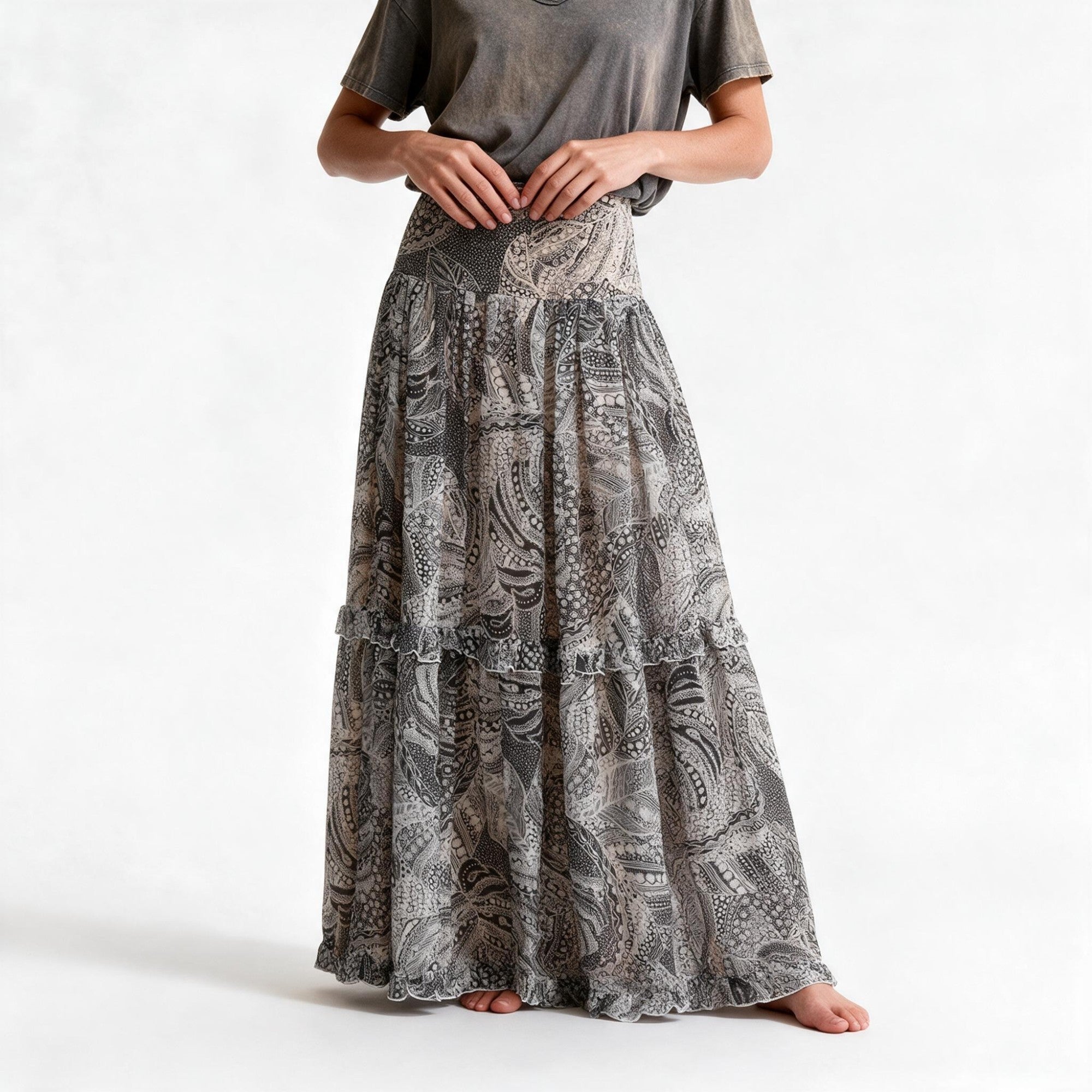 Flowy maxi skirt with multi-toned grey, black, and white paisley pattern, featuring tiered ruffles.