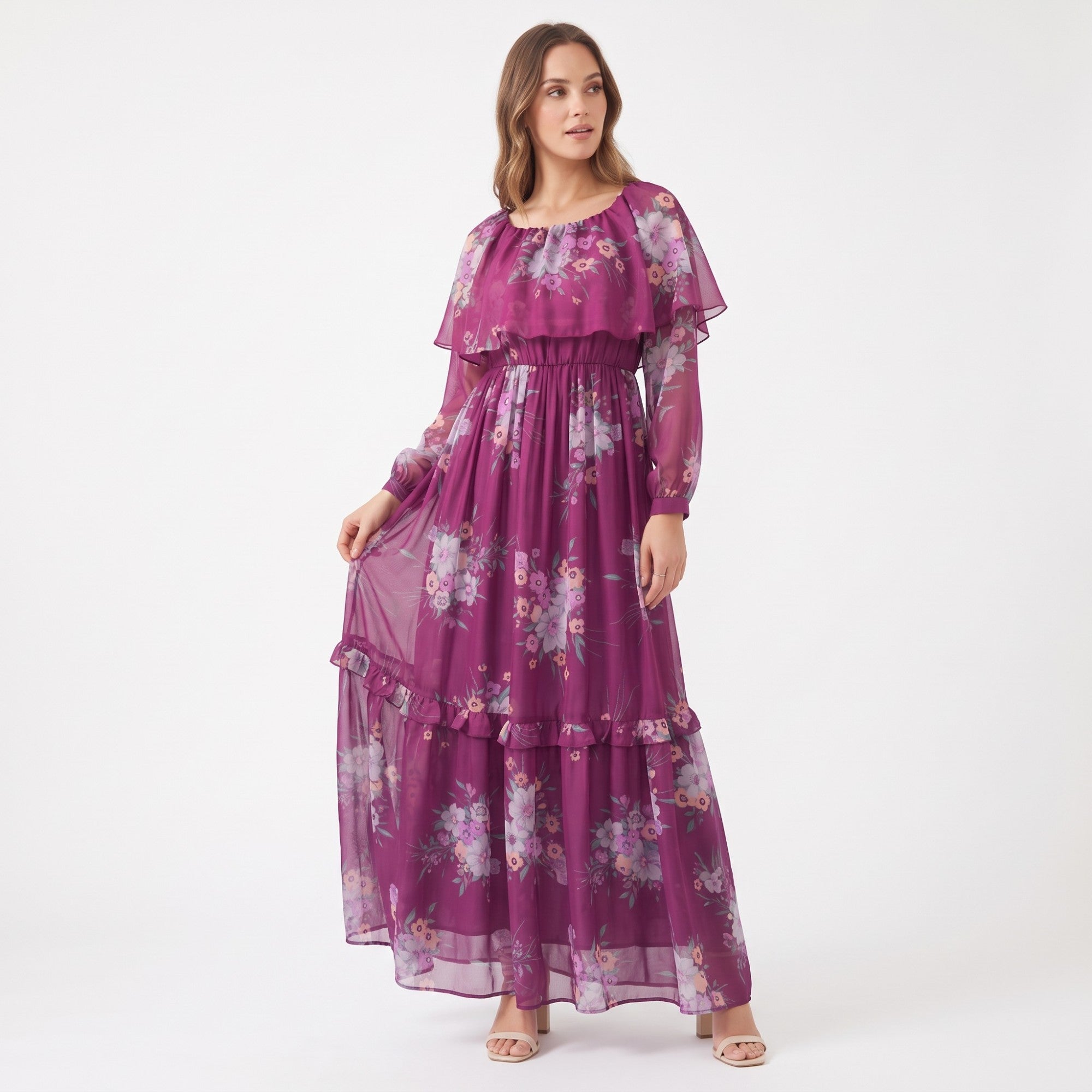 Fuchsia sheer maxi dress with a multi-color floral print, ruffled bodice overlay, elasticated waist, long sleeves, and tiered