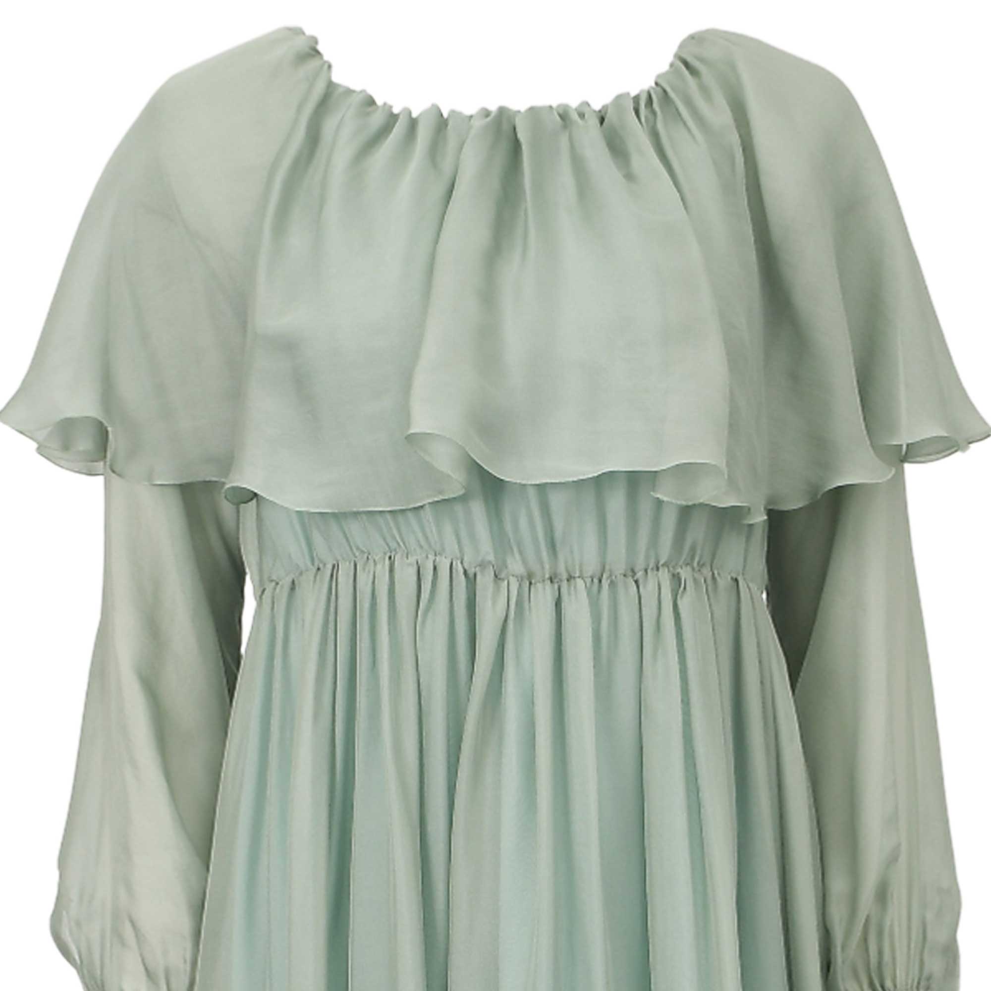 Sage green off-the-shoulder dress with a ruffled overlay, long sheer balloon sleeves, and a gathered waist and skirt.
