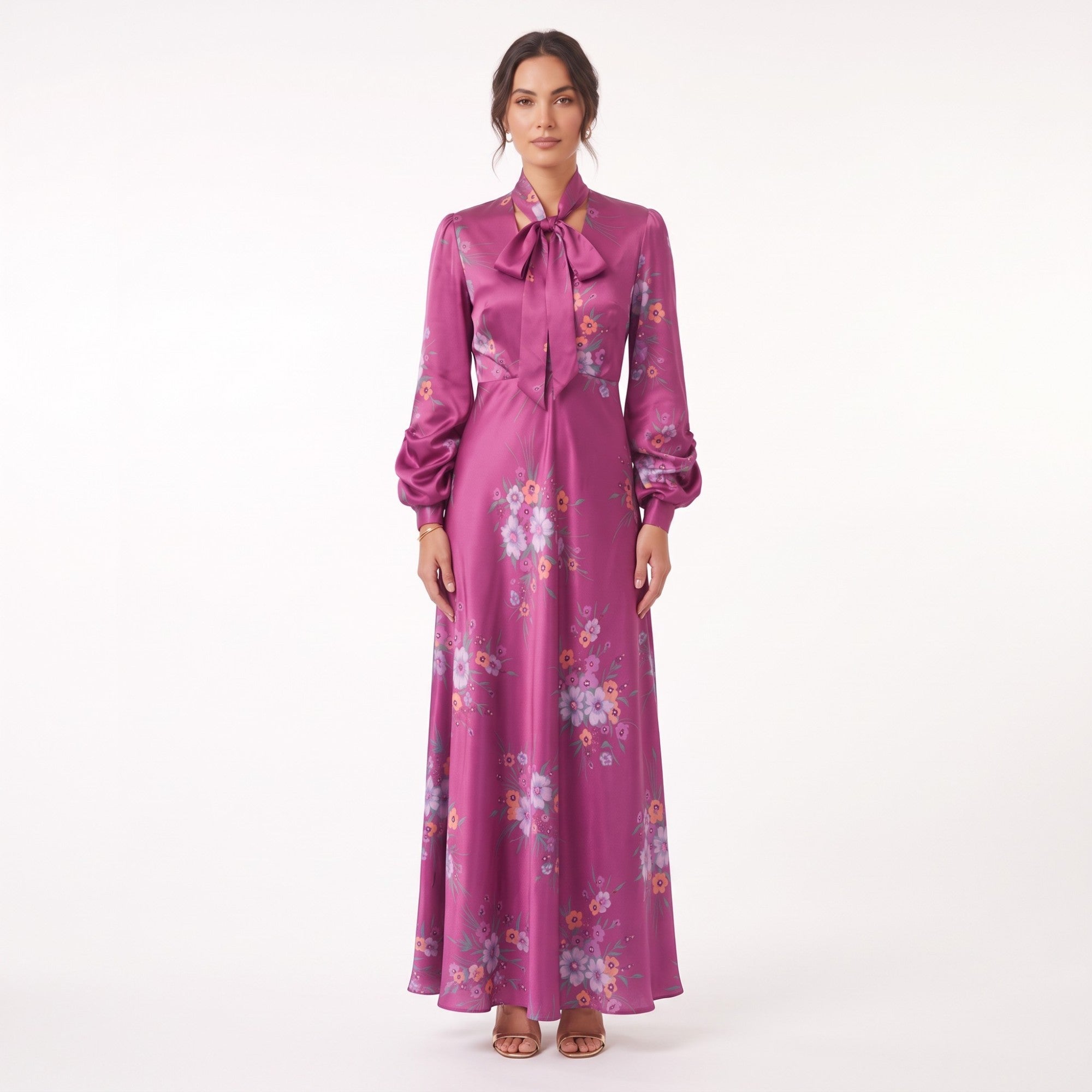 Fuchsia satin-finish maxi dress with a pussy-bow neckline, long gathered sleeves, and a floral print of purple and orange flo