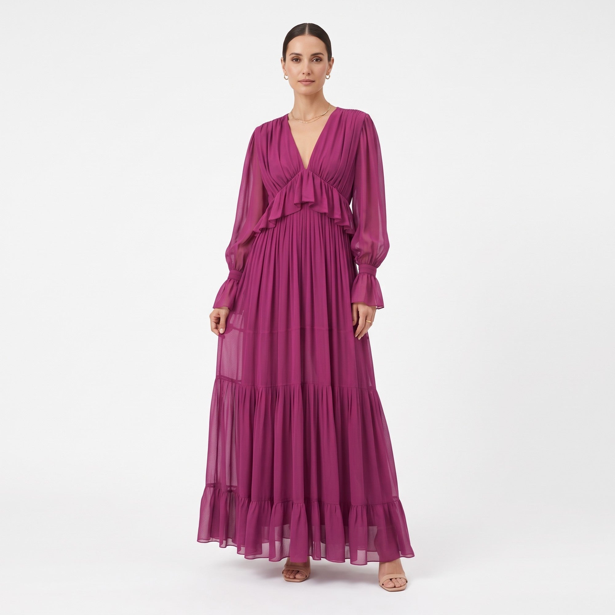 Fuchsia maxi dress with a V-neck, ruffled bodice trim, sheer long sleeves with ruffled cuffs, and a tiered, ruffled skirt.