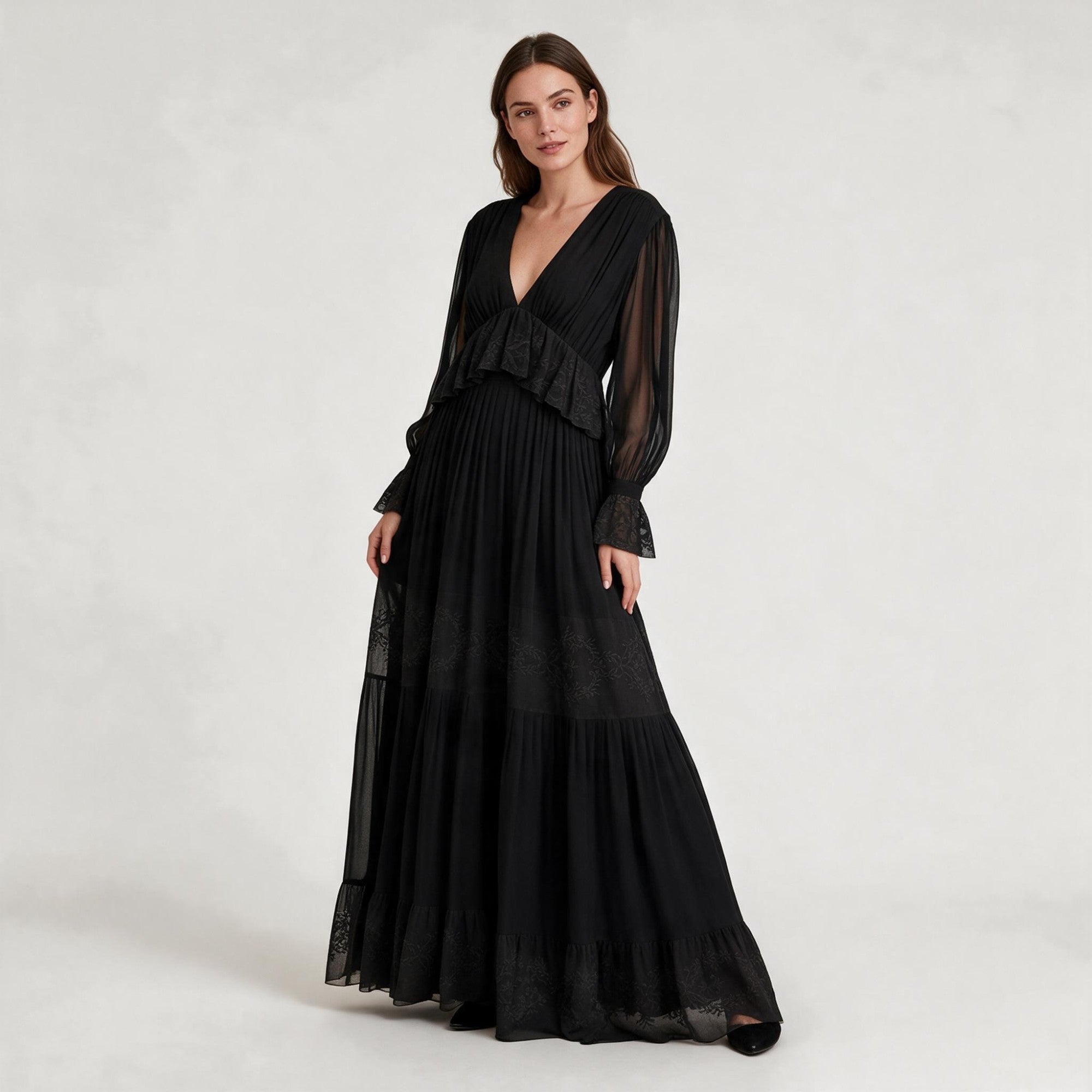 Black maxi dress. V-neck, sheer long sleeves with ruffled cuffs. Ruffled bodice. Tiered skirt with patterns, ruffled hem.