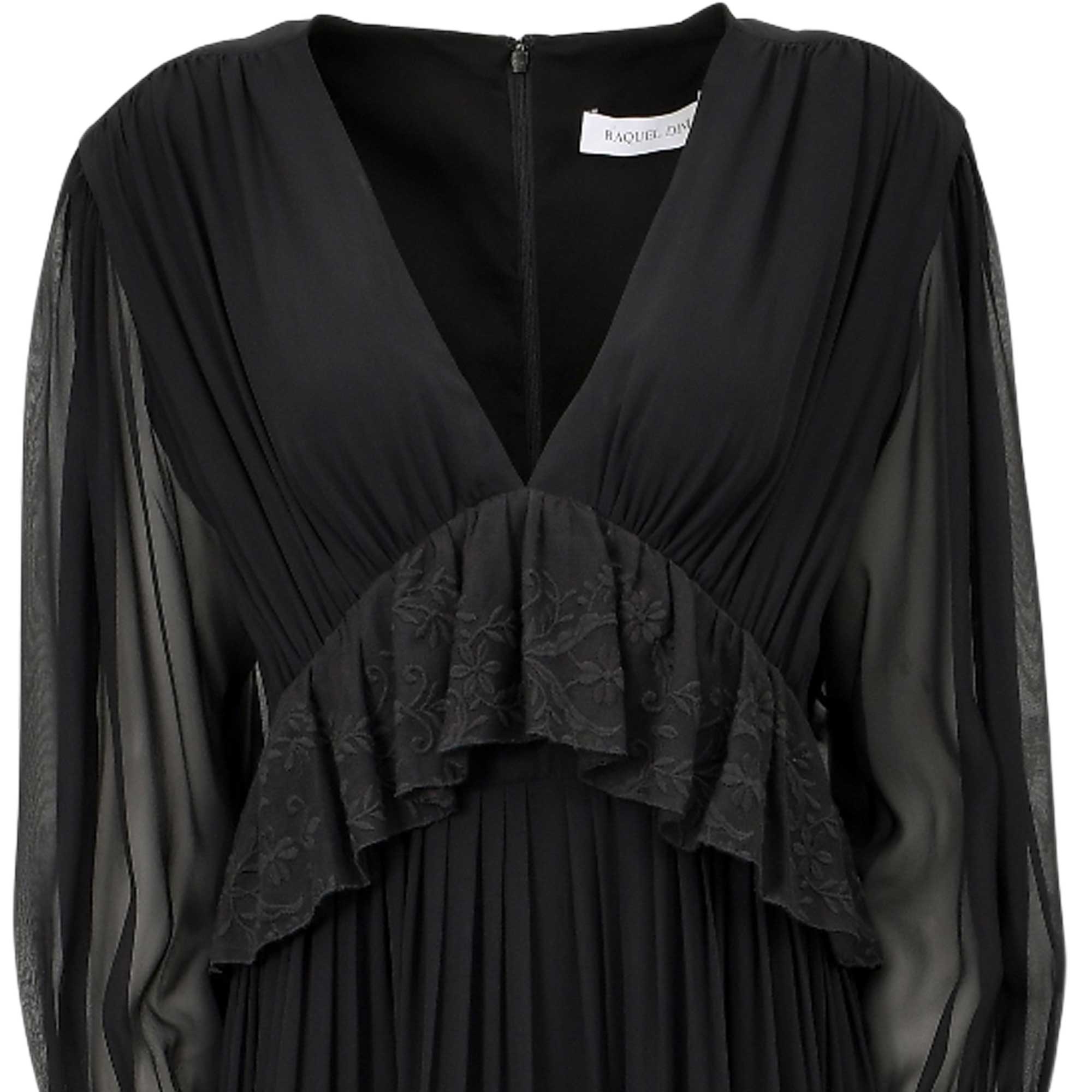 Black V-neck dress with sheer long sleeves, gathered bodice, and a ruffled panel with floral embroidery. Pleated skirt. Back