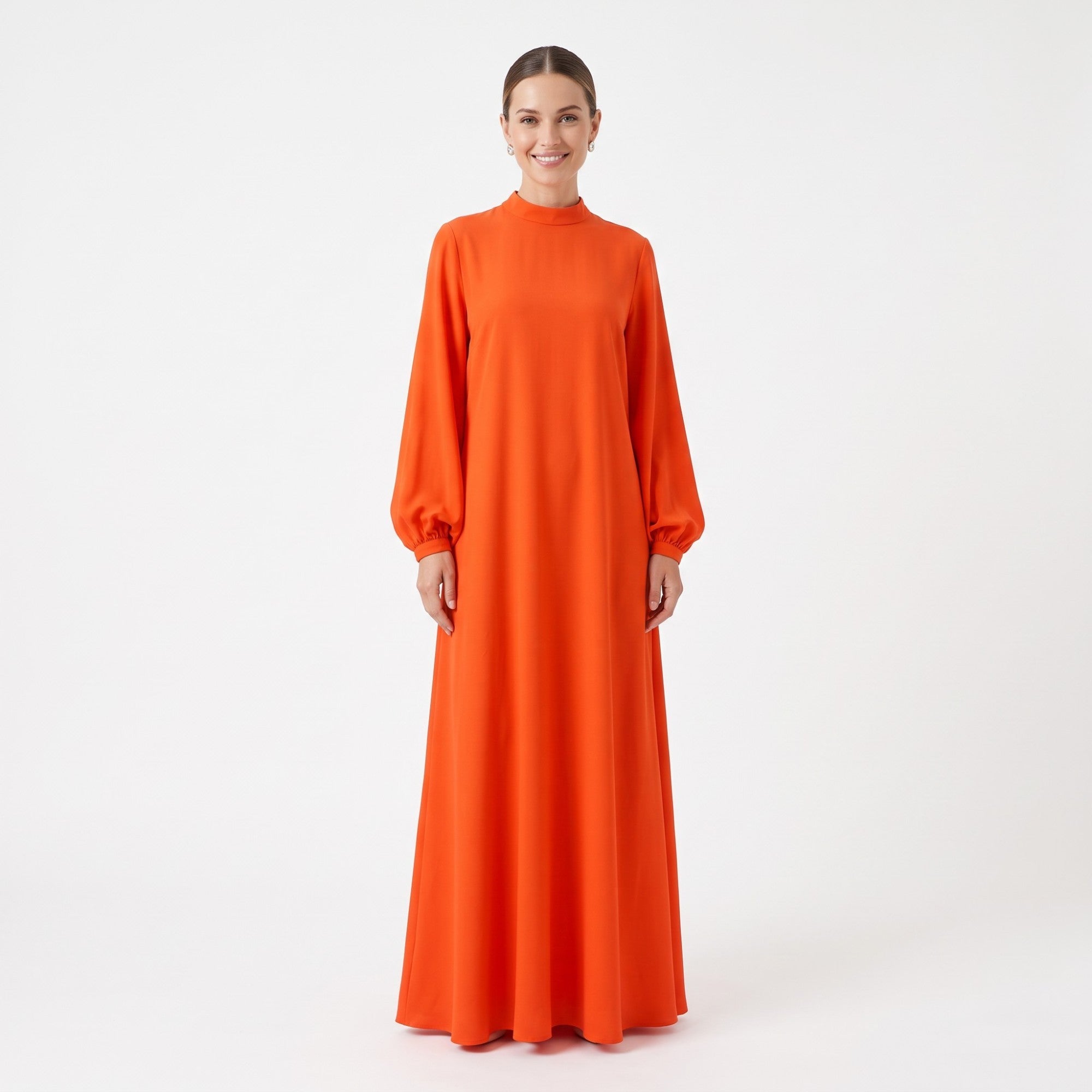 Orange maxi dress with a mock neck, long balloon sleeves with elasticated cuffs, and a flowing A-line silhouette.