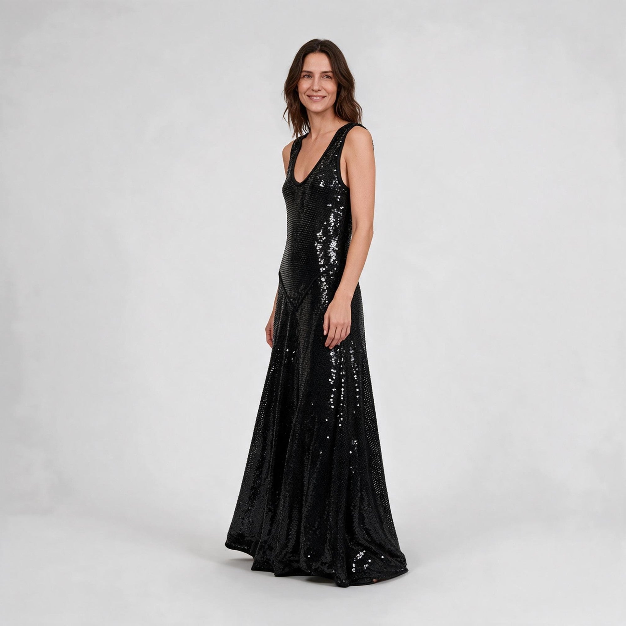 Black sequined maxi dress with a V-neck and sleeveless design. The dress features an angled side panel on the bodice.