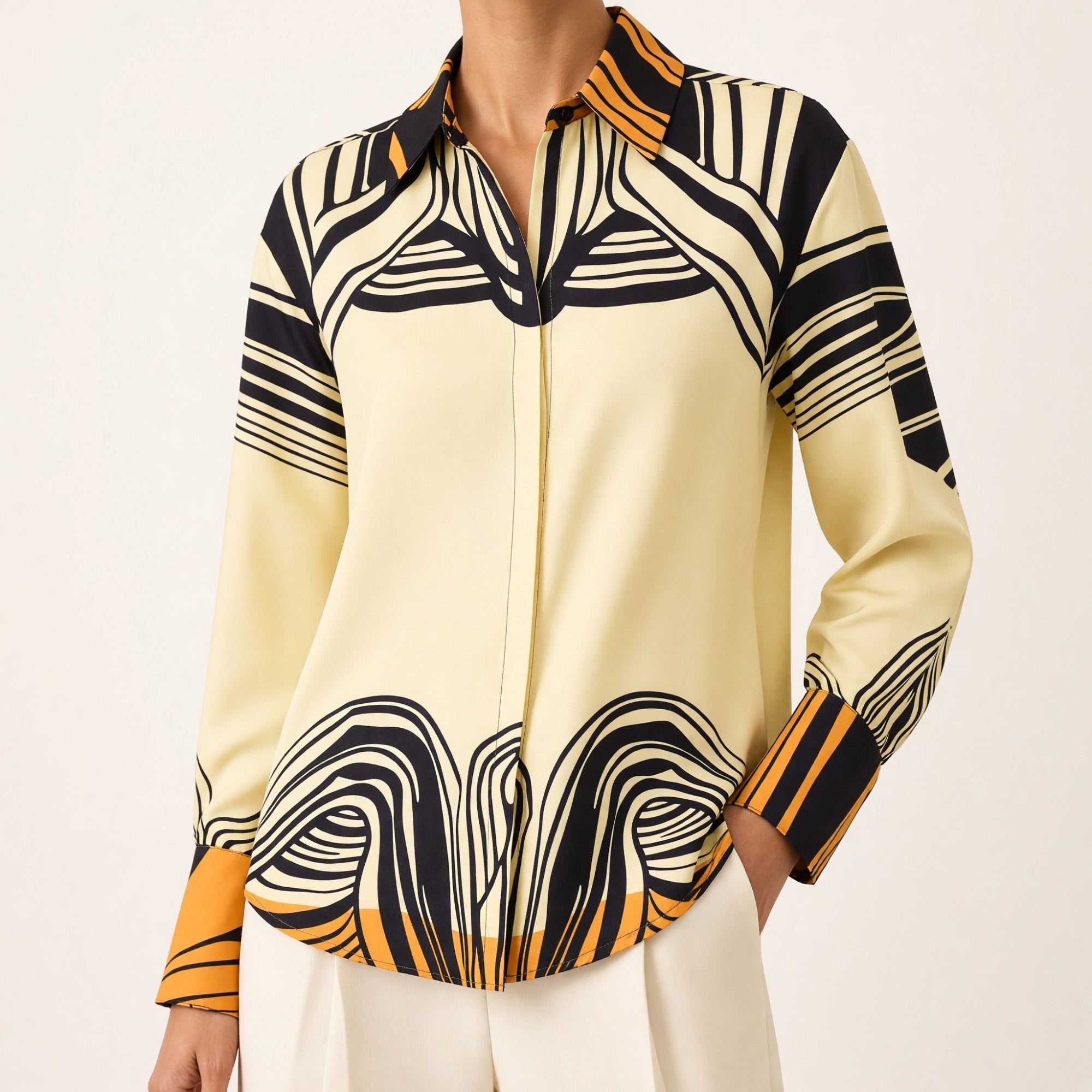 Ivory long-sleeved collared shirt with abstract black and tangerine wavy patterns on the collar, shoulders, cuffs, and hem.