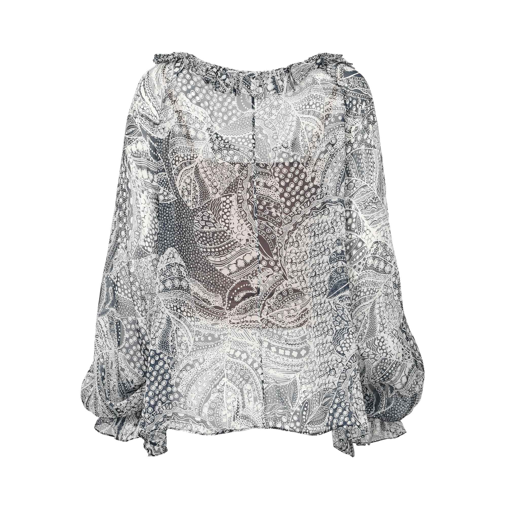 Sheer blouse with a monochrome abstract pattern, ruffled elasticized neckline, and long puffed sleeves with ruffled cuffs.
