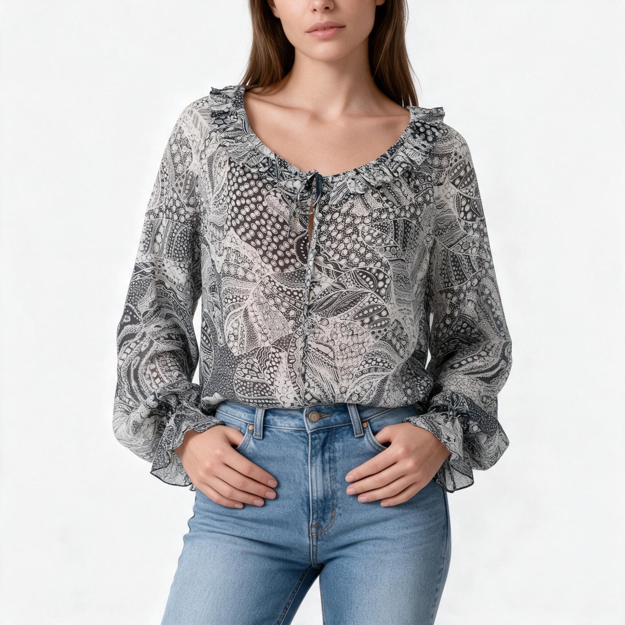 Sheer black, white, and grey patterned blouse with long ruffled sleeves, a ruffled neckline, and a tie-front V-neck.