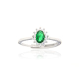 Silver-toned adjustable ring with an oval green stone surrounded by a halo of small clear stones.