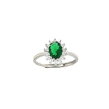 Silver-toned ring with an oval emerald-green stone surrounded by a halo of clear round stones, on an adjustable band.