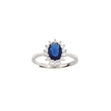 Silver-toned adjustable ring with an oval deep blue stone surrounded by a halo of small clear stones.